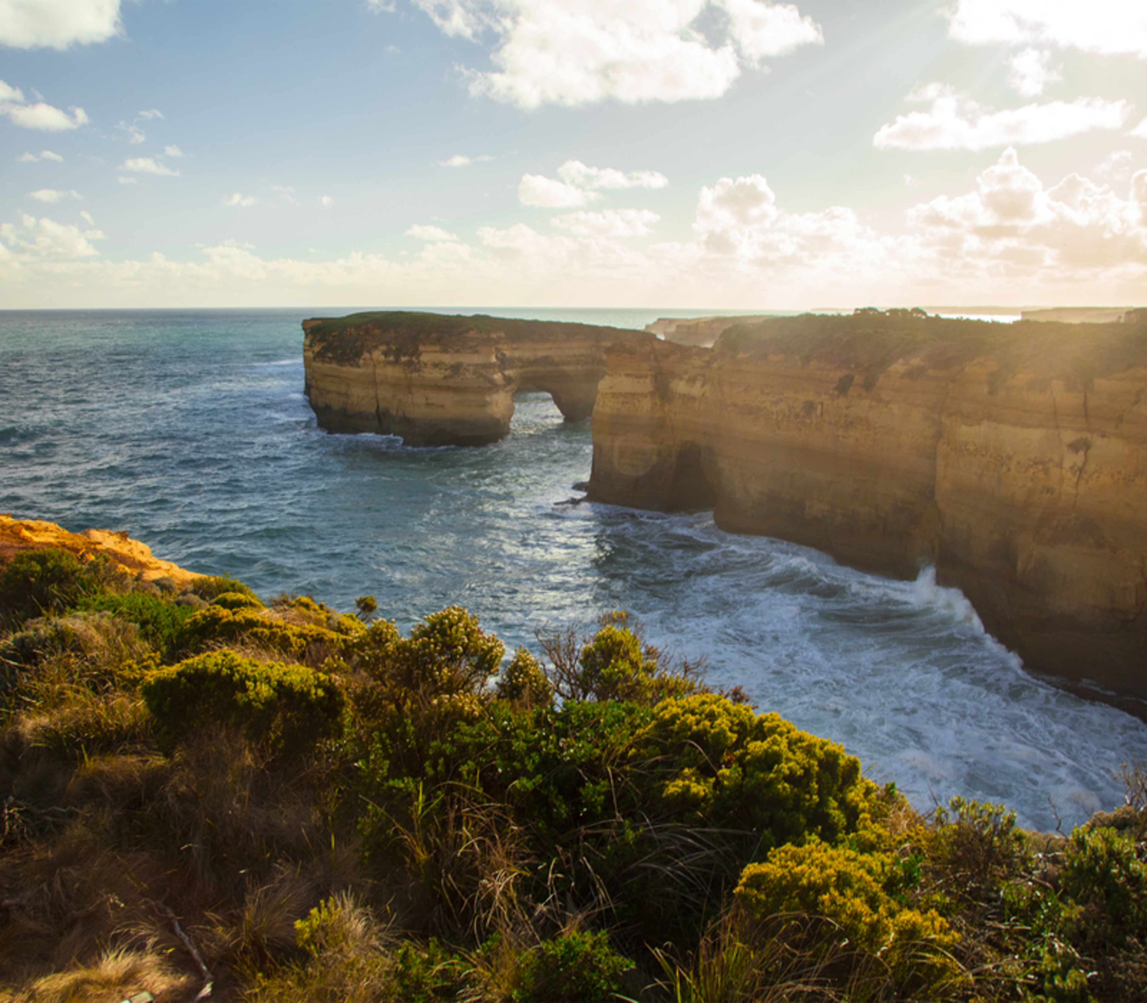 Coastal view of the Twelve Apostles limestone formations and steep cliffs along the Great Ocean Road in Victoria.