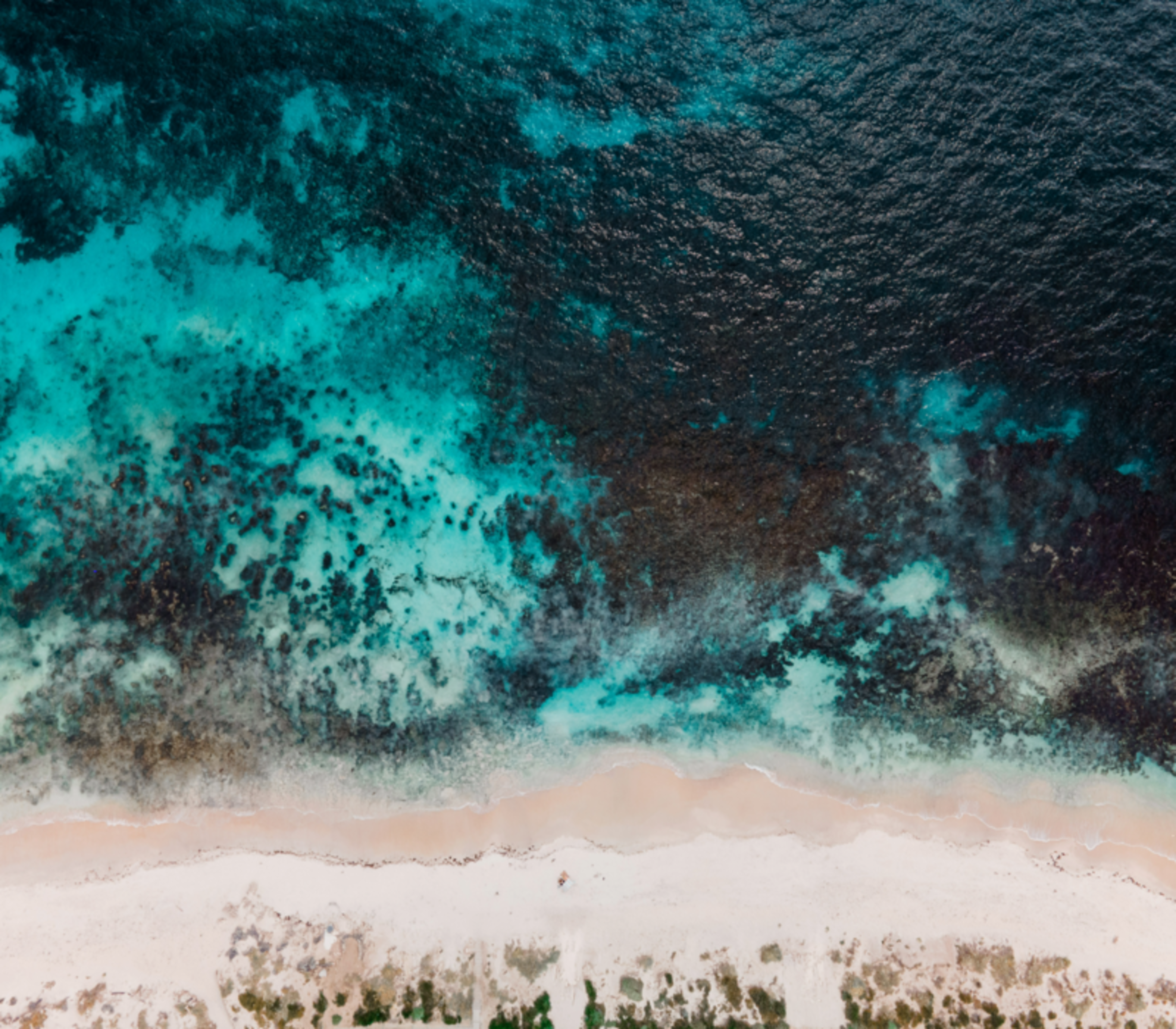 Birds eye view of a sandy beach with reef on the West Coast.