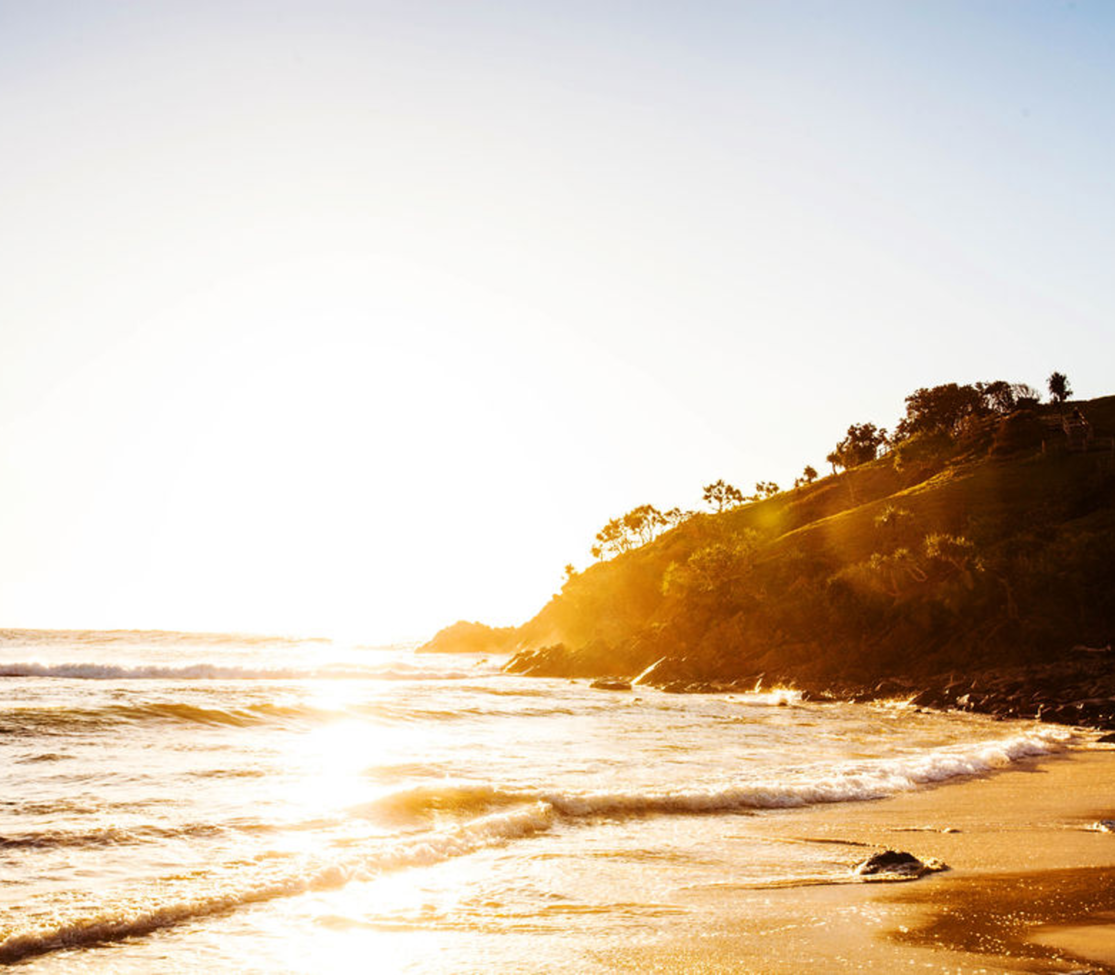Golden sunset over Norries Headland and Cabarita Beach surf in Northern Rivers New South Wales.