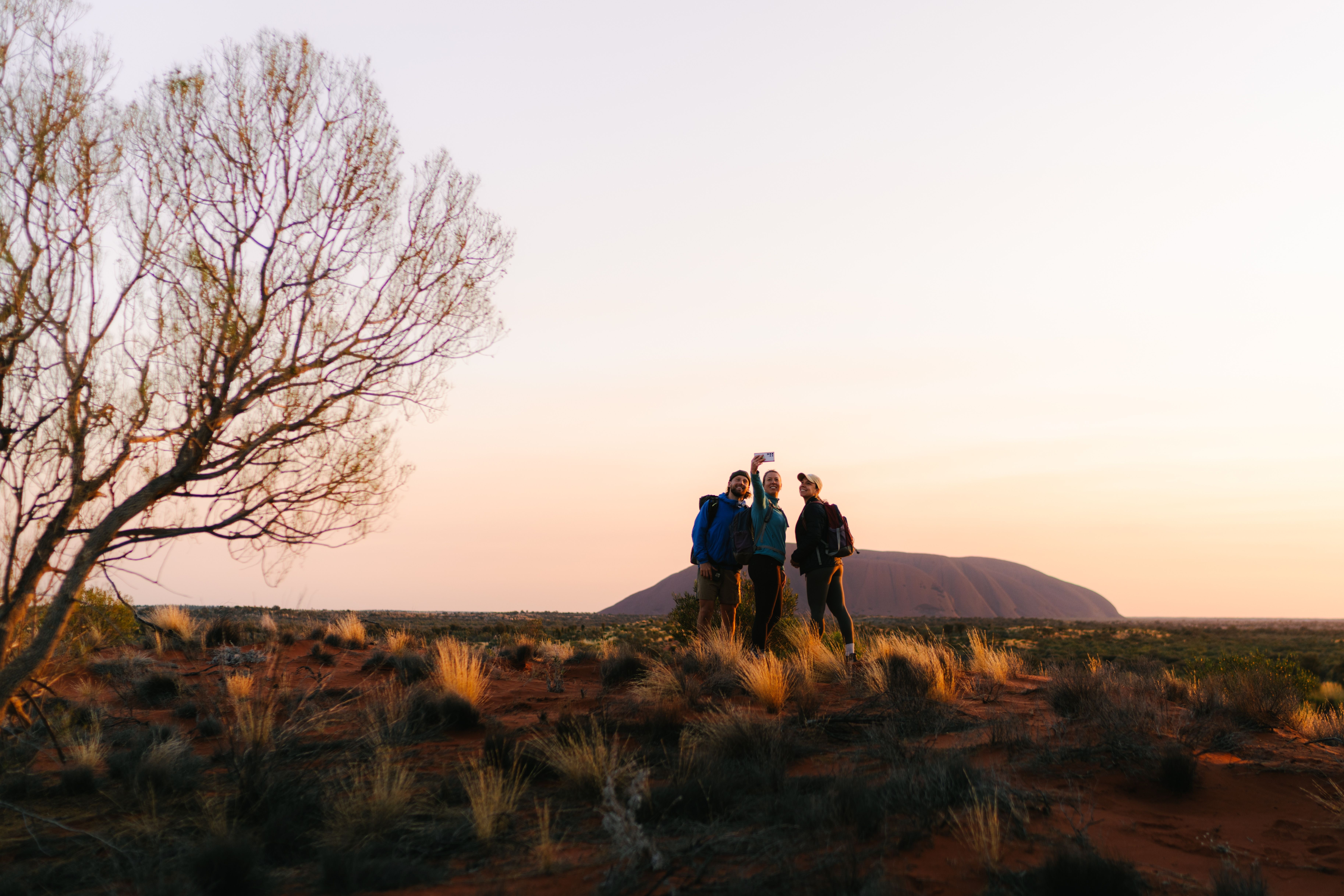 Travellers on the Uluru Signature Walk in the Northern Territory