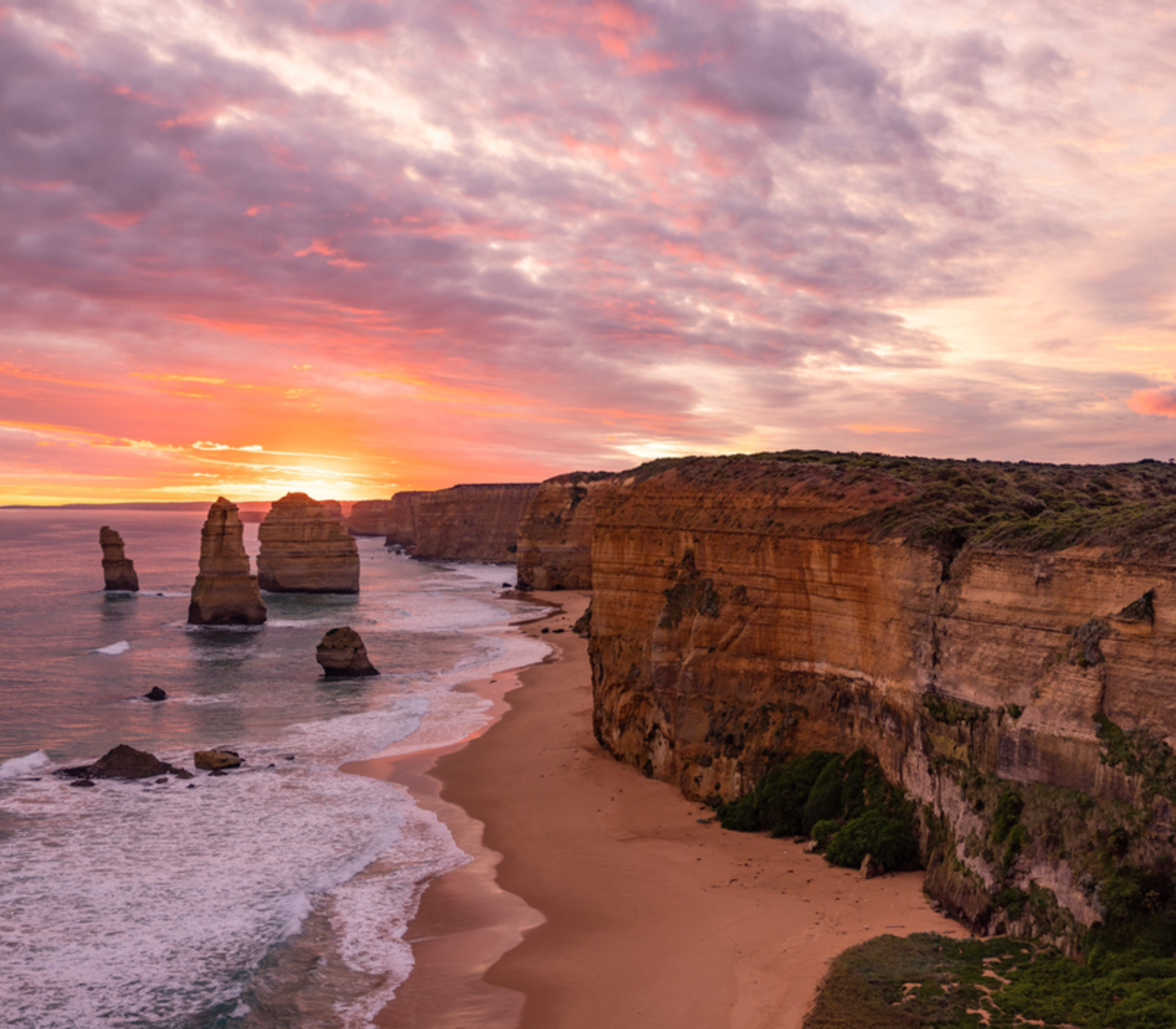 Iconic limestone rock formations of the Twelve Apostles at sunset along the Victorian coastline.